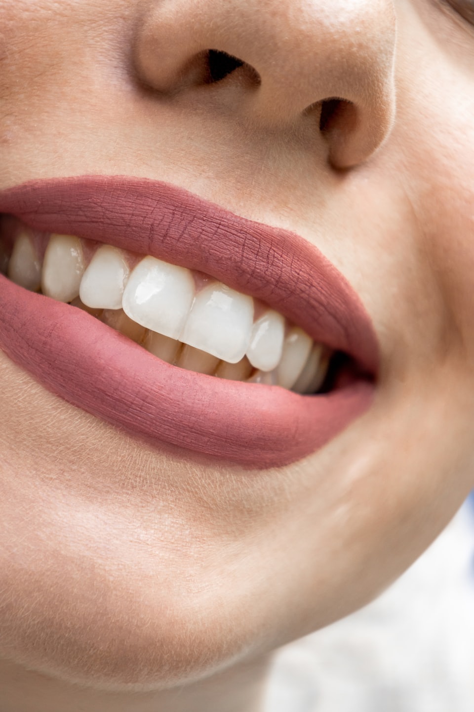 whitening maintenance products close up bright white smile pink lipstick