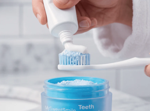 Adding toothpaste over MySweetSmile whitening powder for the morning routine
